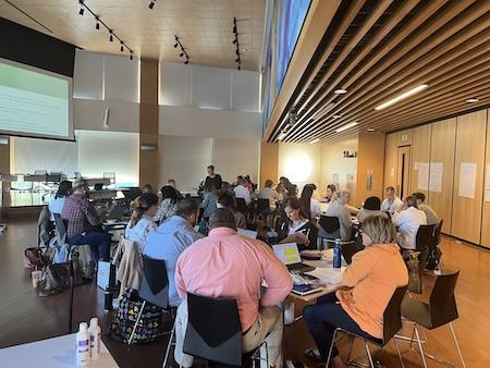 People sitting at tables at a conference