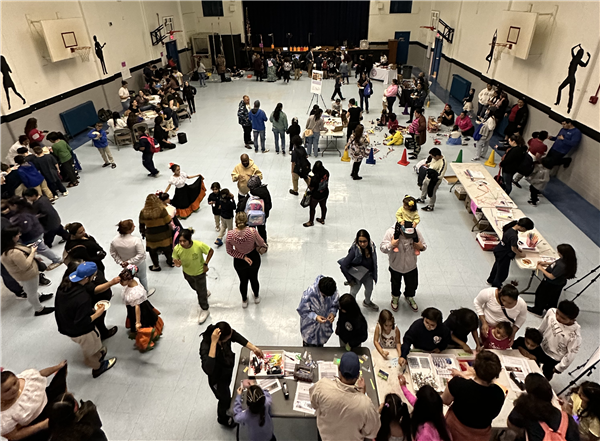 Families attending an event in the gymnasium Families attending an event in the gymnasium